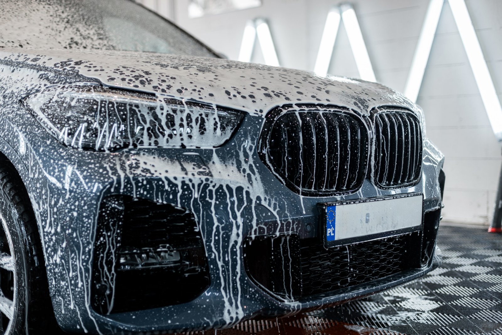 car-is-washed-professional-car-wash-man-washes-car-with-foam-detailing-scaled-1.jpg